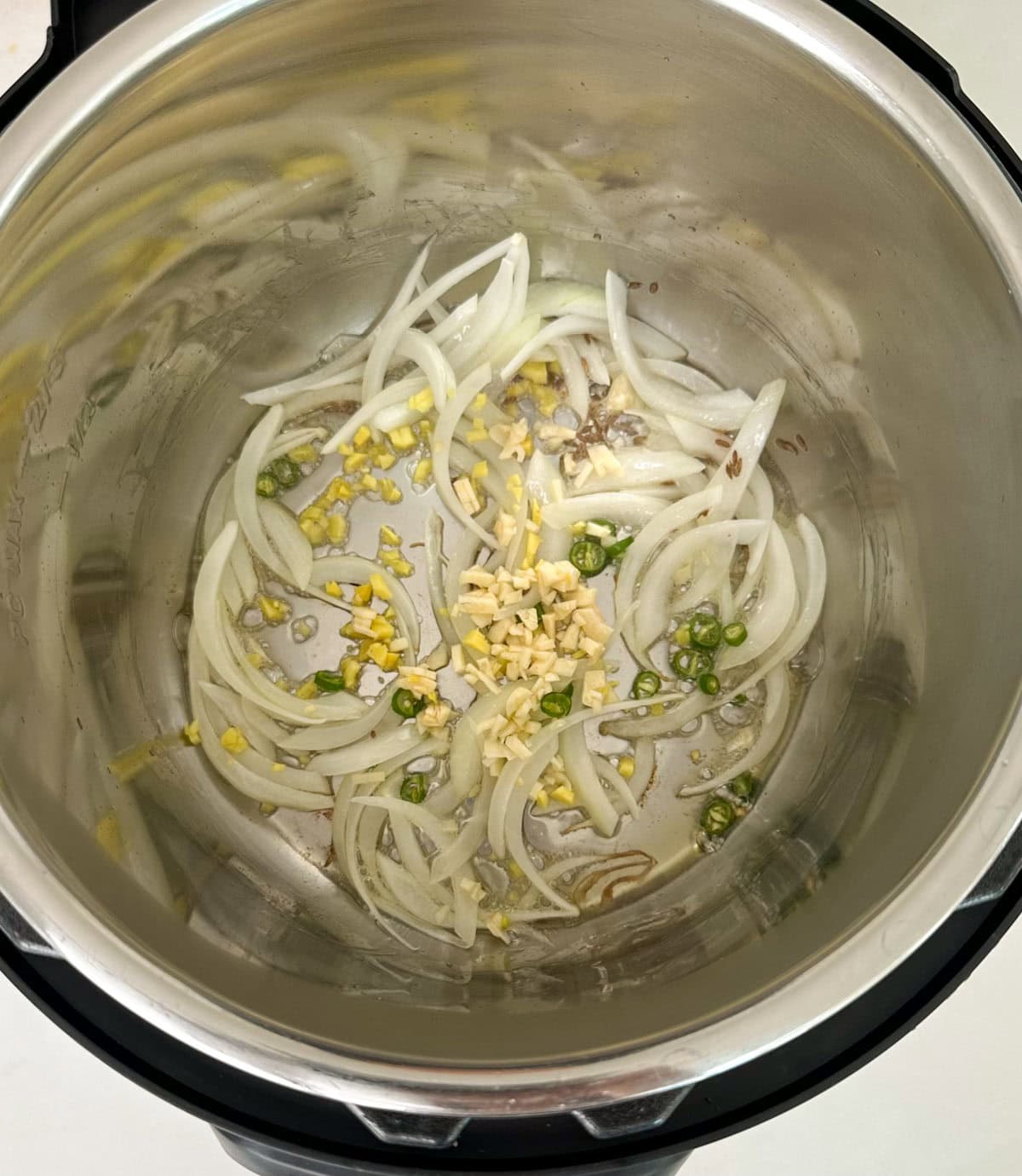 Saute onions, ginger, garlic and green chili in instant pot to make aloo gobi recipe