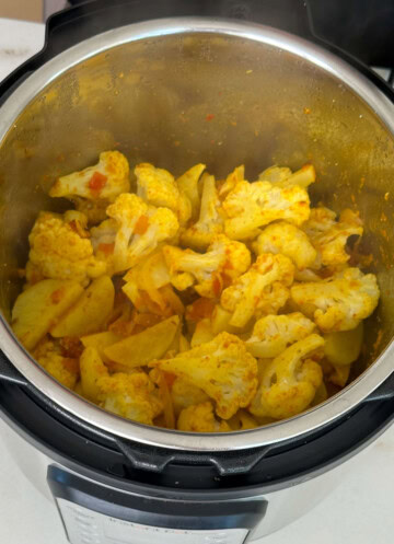 Stir ingredients for aloo gobi recipe