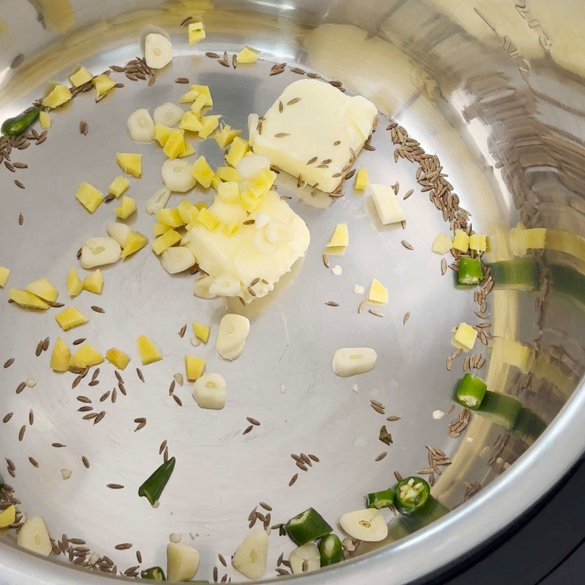 Saute cumins seeds, garlic, ginger green chili for paneer butter masala recipe