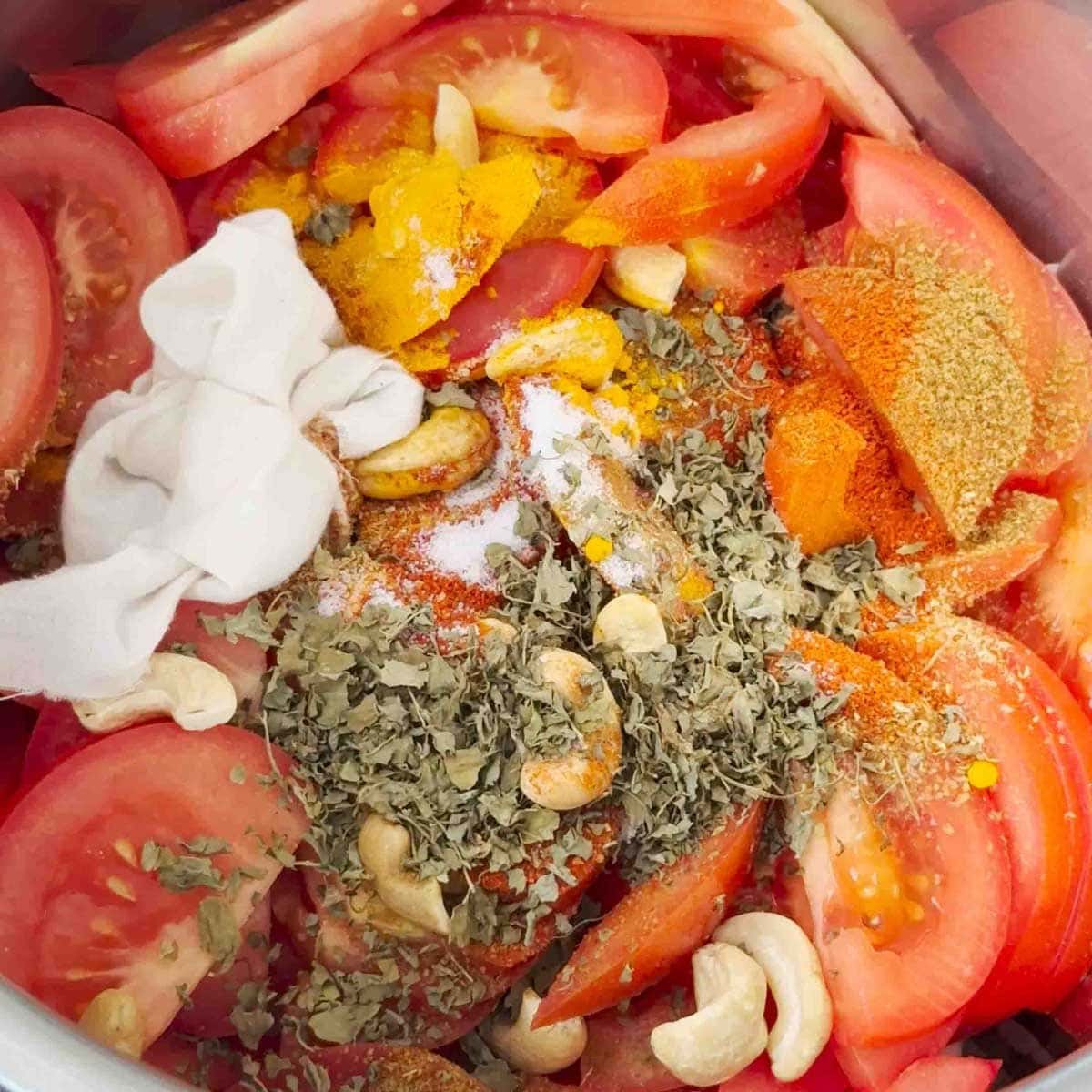 Add spices into the instant pot for paneer butter masala