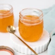 Close-up shot of ghee in a jar with spoon on the side