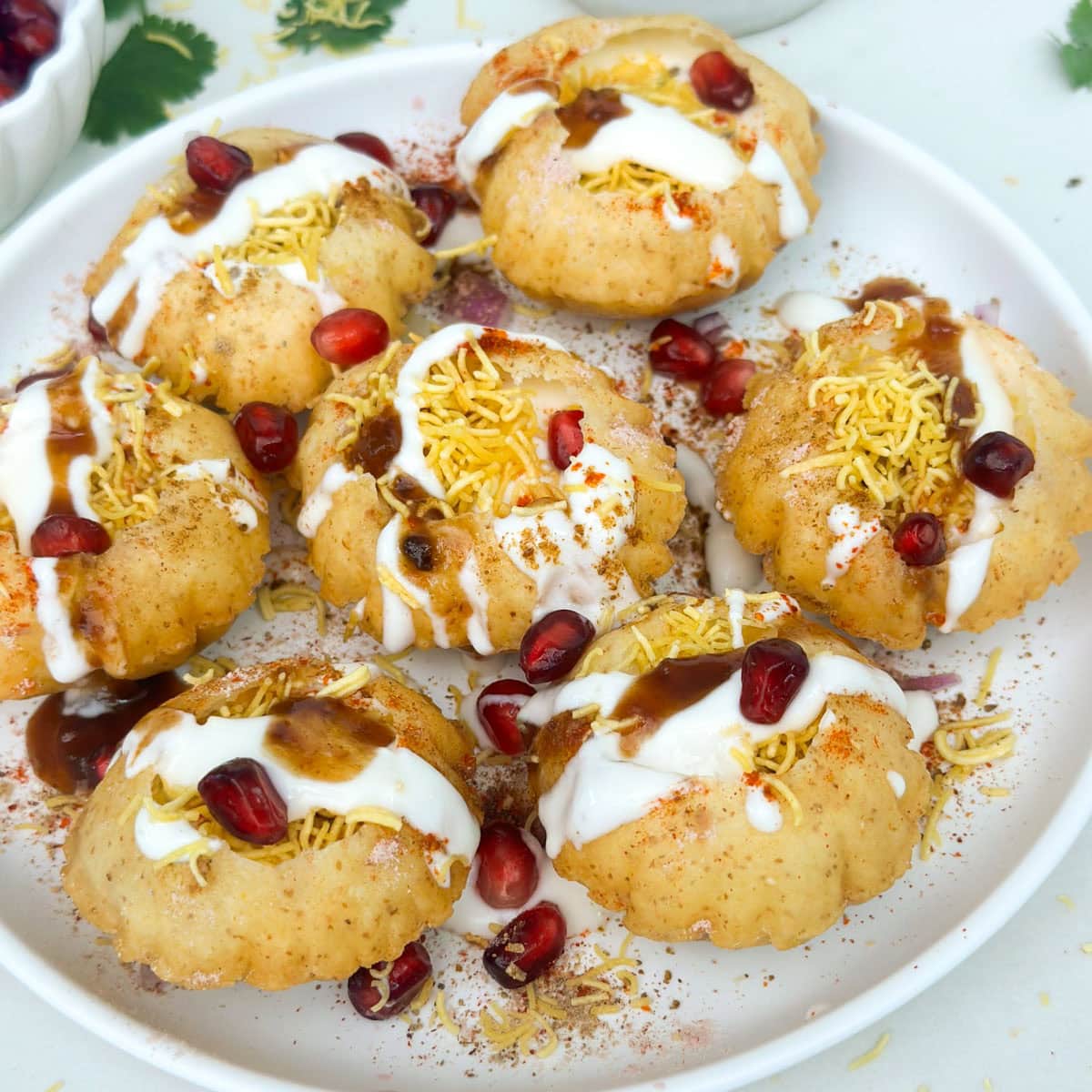 Closeup shot of dahi puri on a white plate
