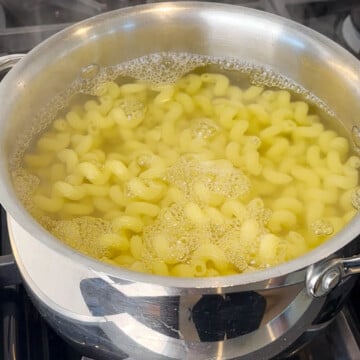 Boil elbow macaroni in a pot for Masala mac and cheese
