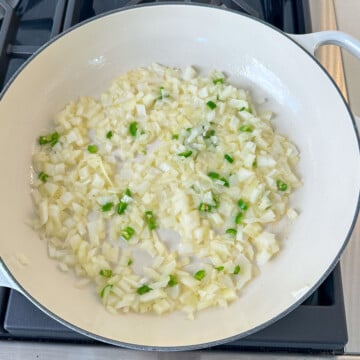 Saute onion and pepper in a pan for spicy mac and cheese recipe