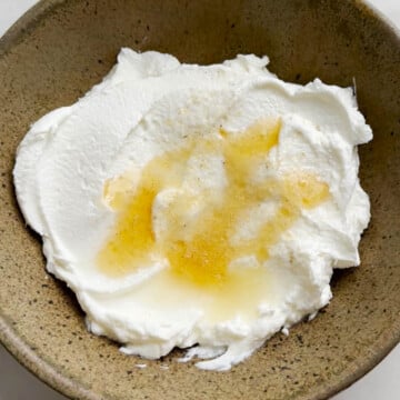 Curd in a bowl with lemon juice for roasted carrot recipe
