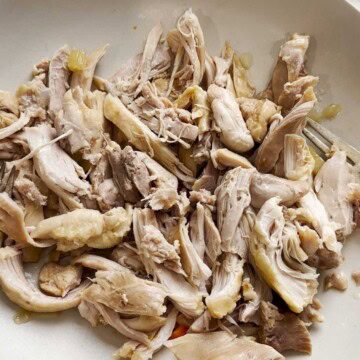Shredded chicken on a plate for chicken noodle soup