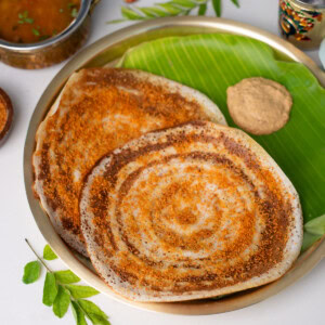 Closeup shot of Ghee Podi Dosa on a brass plate