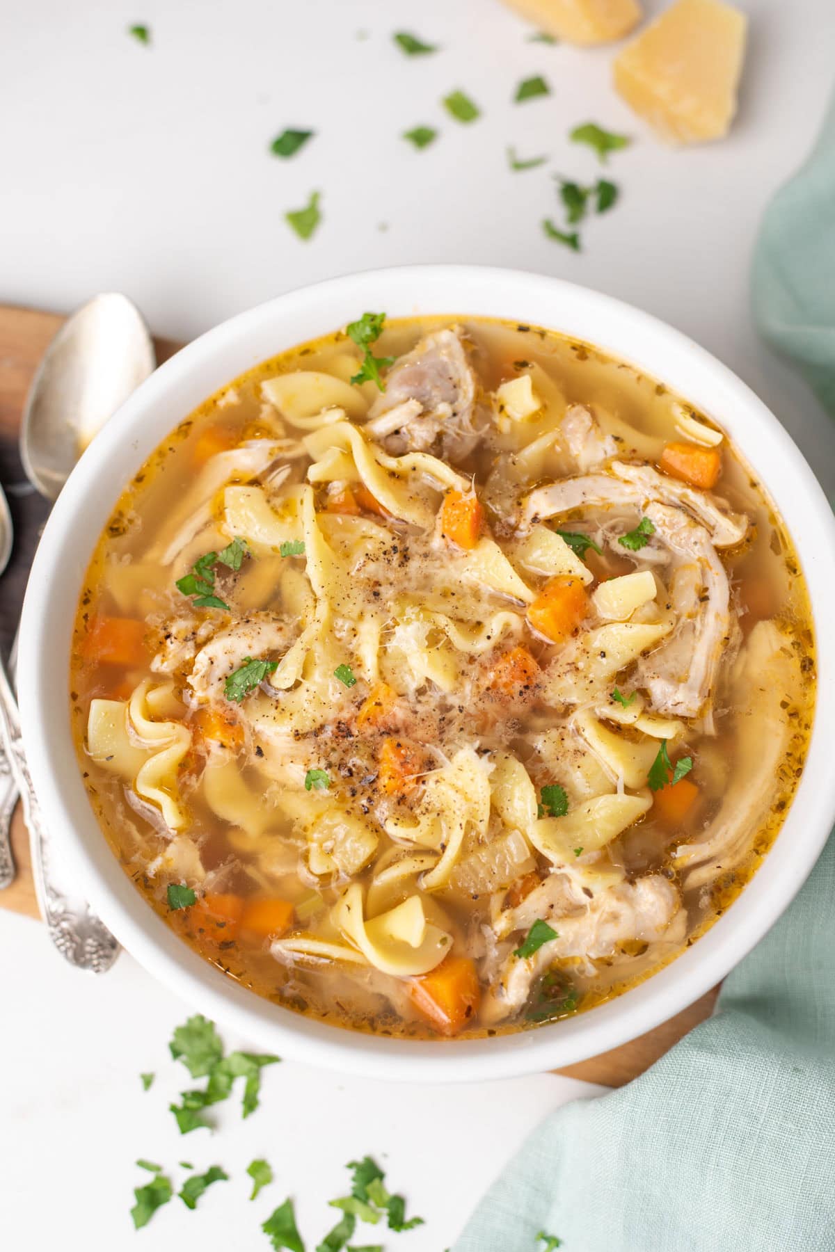 Chicken noodle soup made in instant pot served in a white bowl.