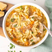 Chicken noodle soup in a white bowl.