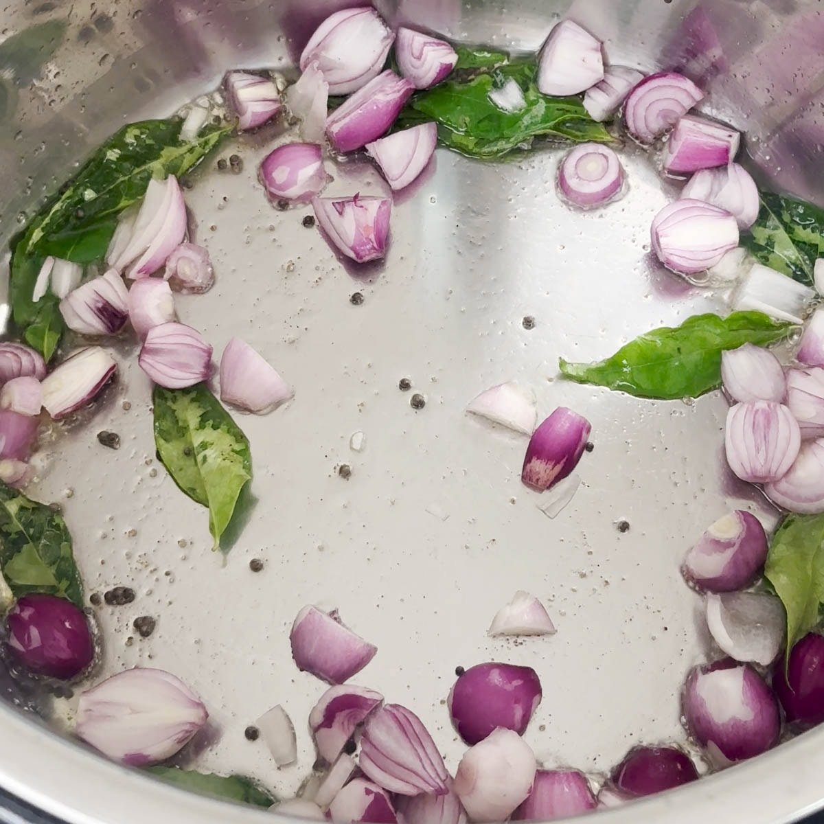 Add pearl onions, curry leaves to make sambar in pressure cooker.