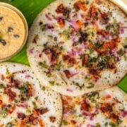 Uttapam on a brass plate with banana leaves