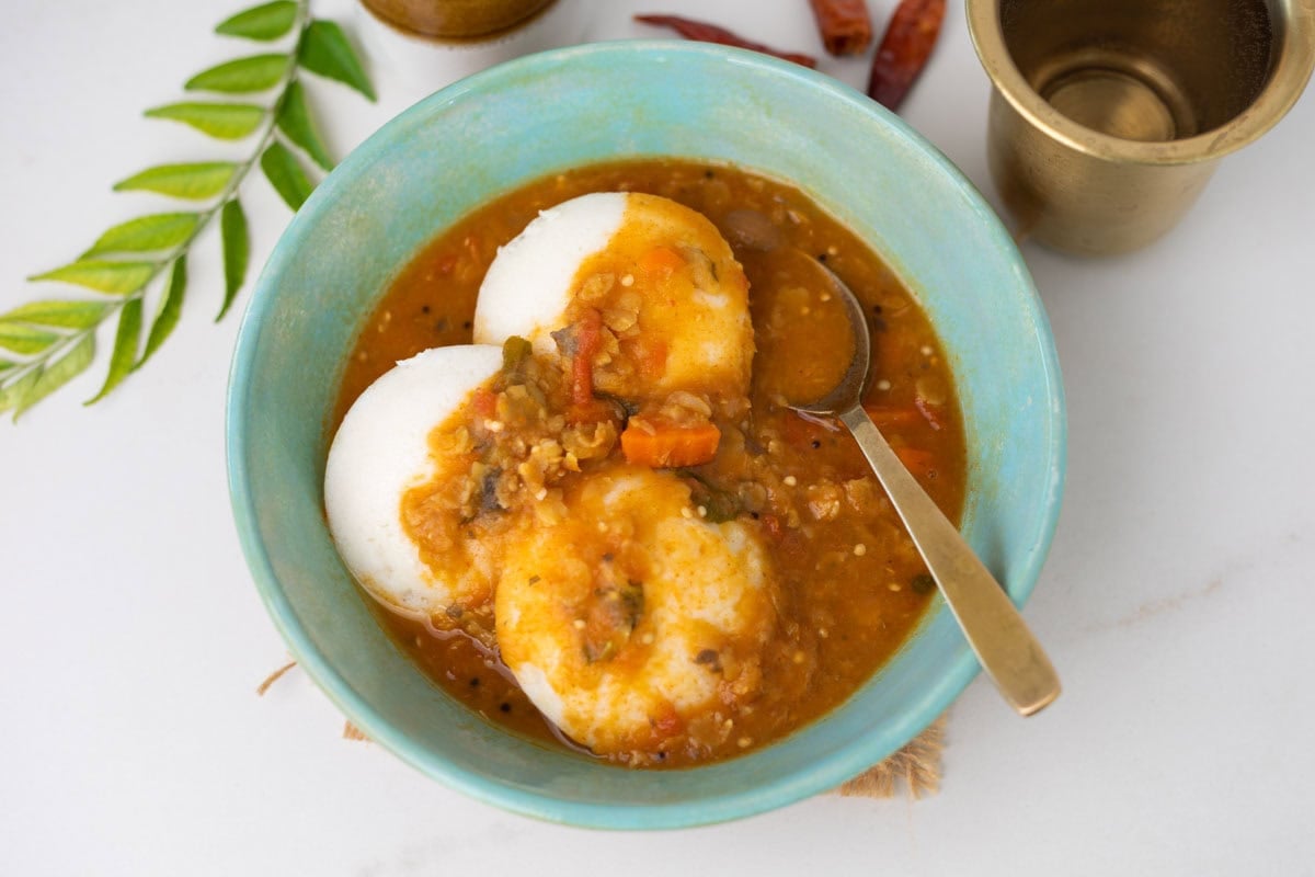 Idli sambar served in a green bowl