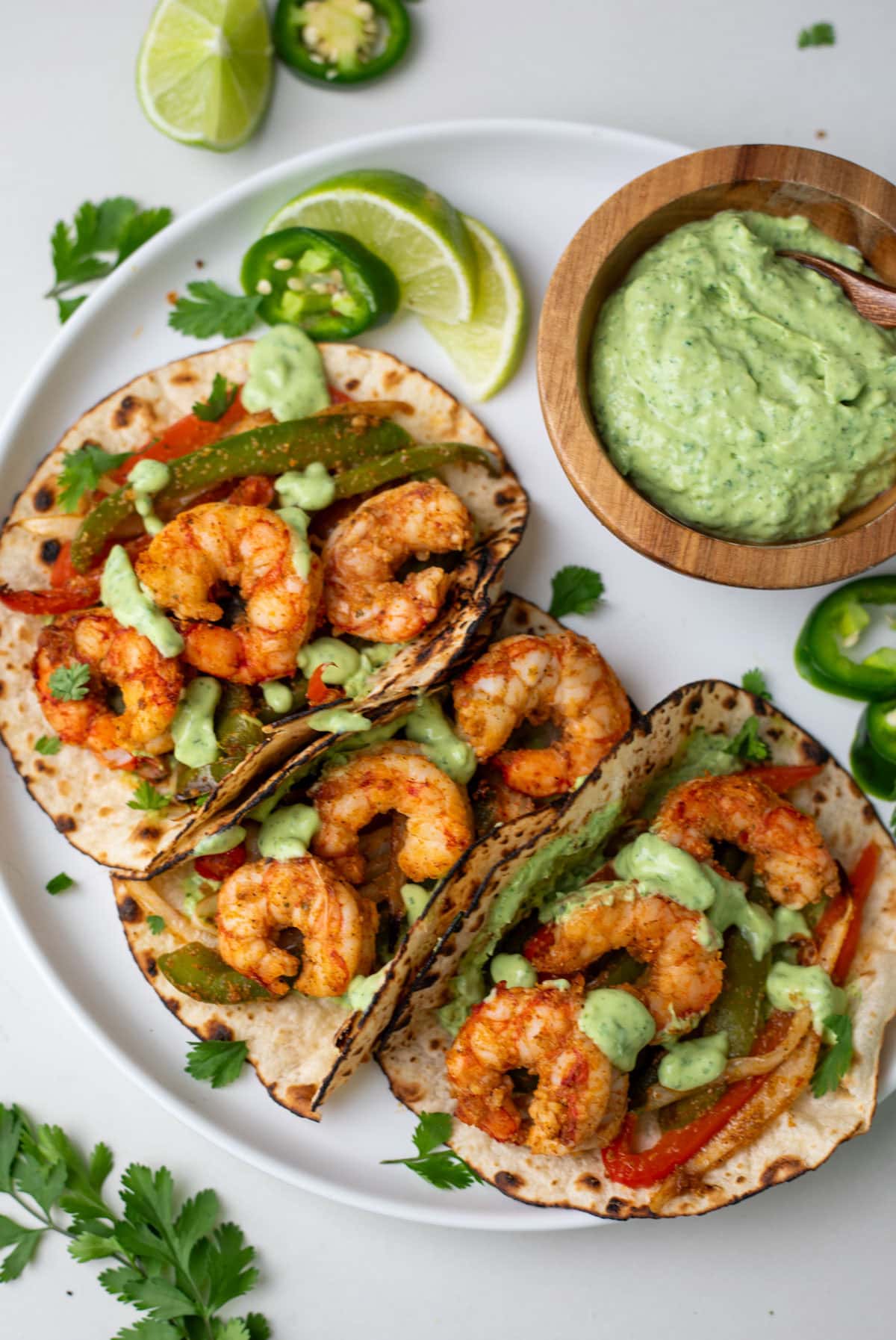Shrimp fajita tacos on a white plate with chutney on side