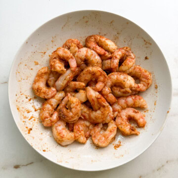 Shrimp with spices on a white plate