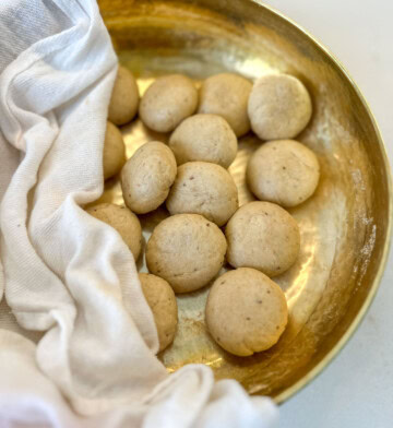 Dough balls in a brass bowl for puri recipe