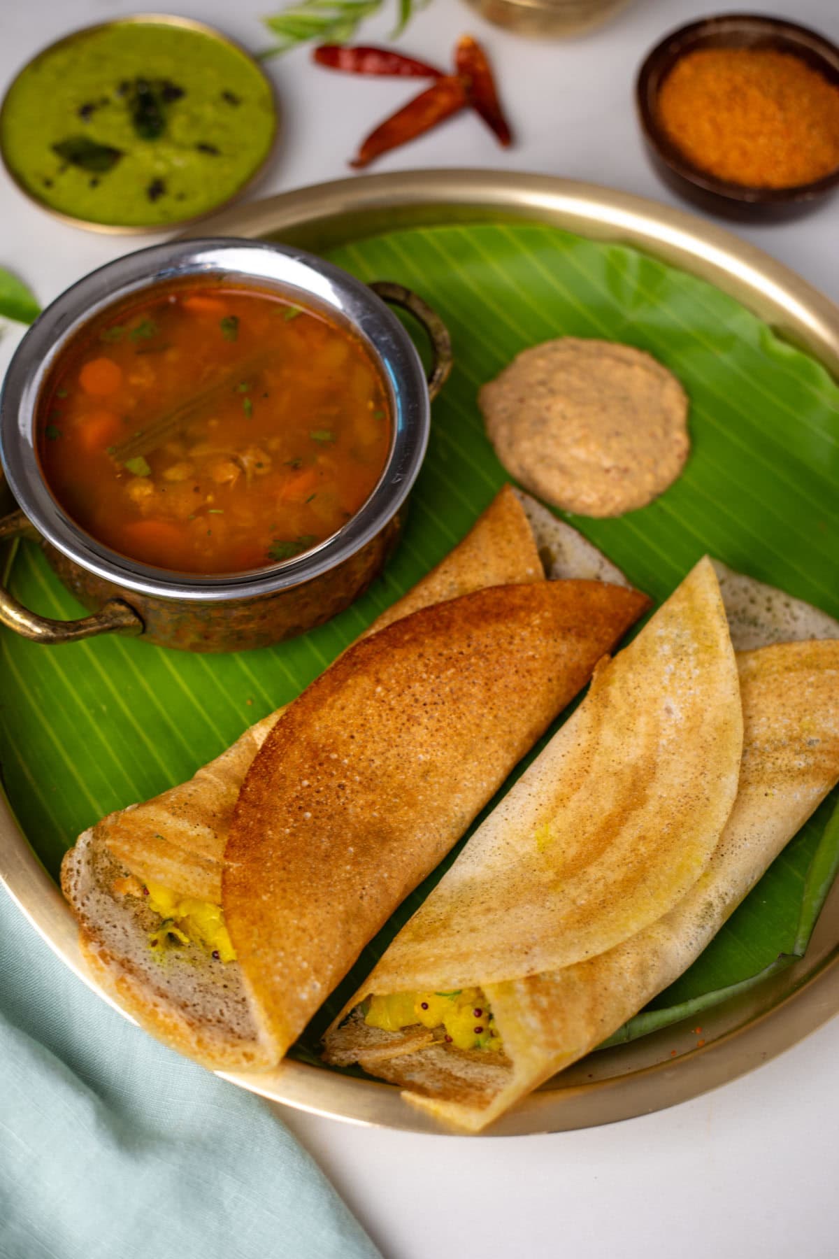Masala dosa with sambar and chutney on a brass plate