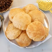homemade poori in a brass plate