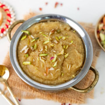Sooji ka halwa (Sheera) served in a bowl, and topped with slivered nuts.