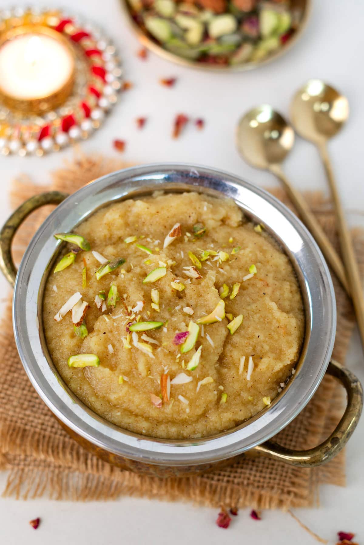 Indian Sooji halwa (Sheera) served in a bowl, and topped with slivered nuts.