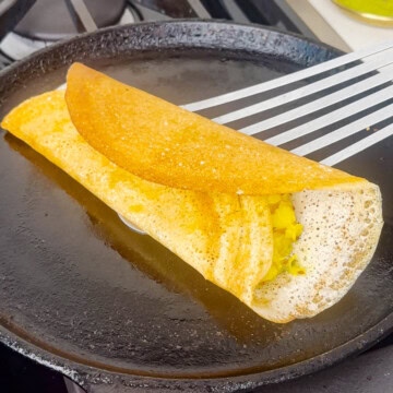 Cooked masala dosa on a cast iron