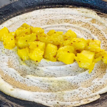 Add potato on the dosa