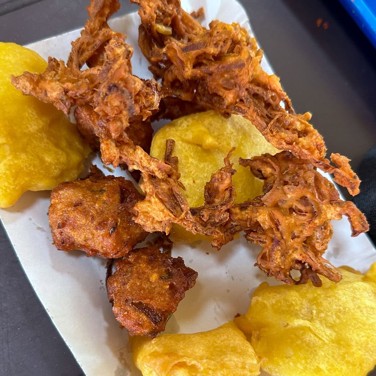 Crispy onion bhaji and aloo pakora served in a plate