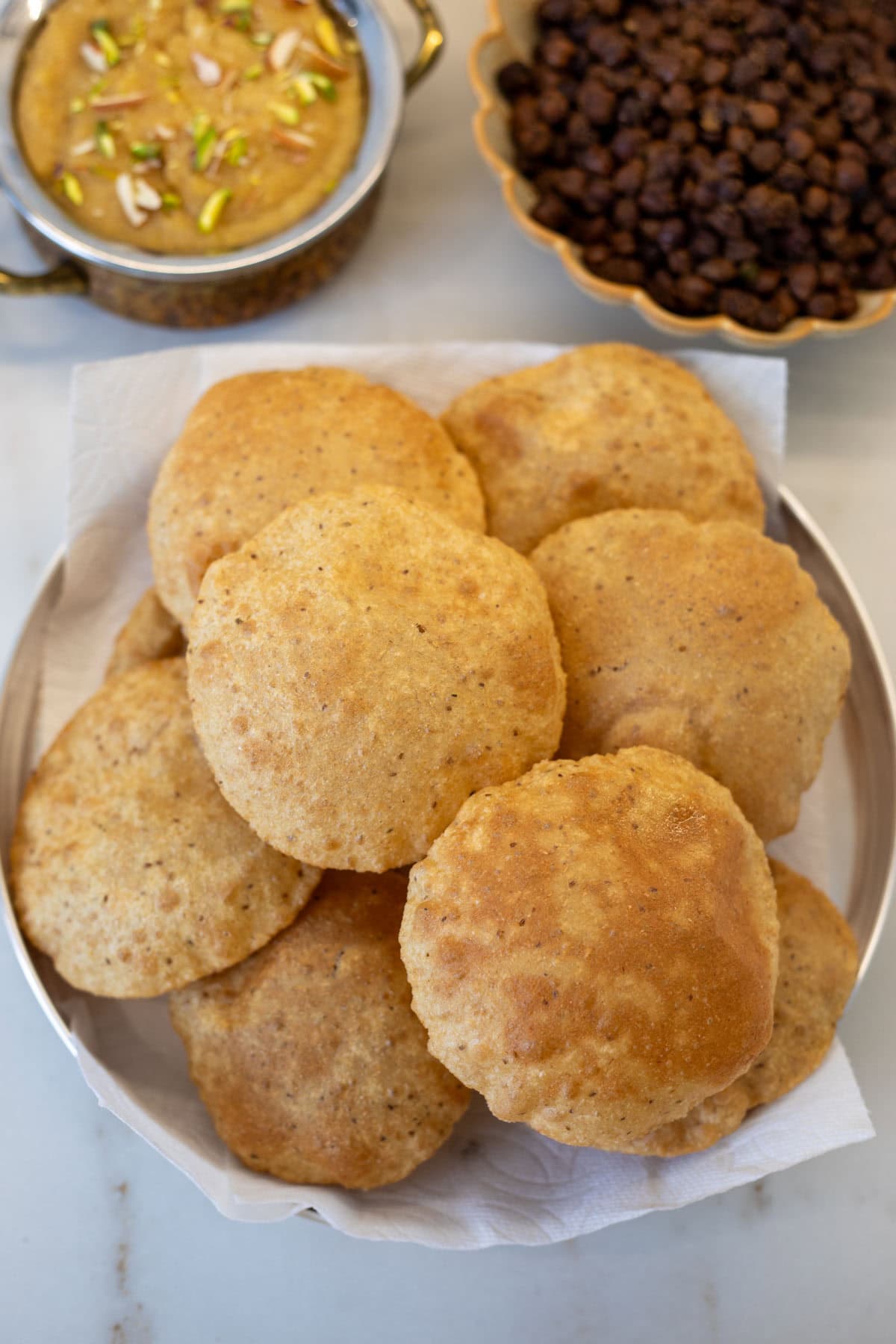 Ready to serve puri in a brass plate