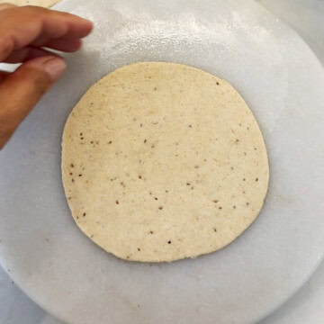 Rolled dough on a marble base for puri recipe
