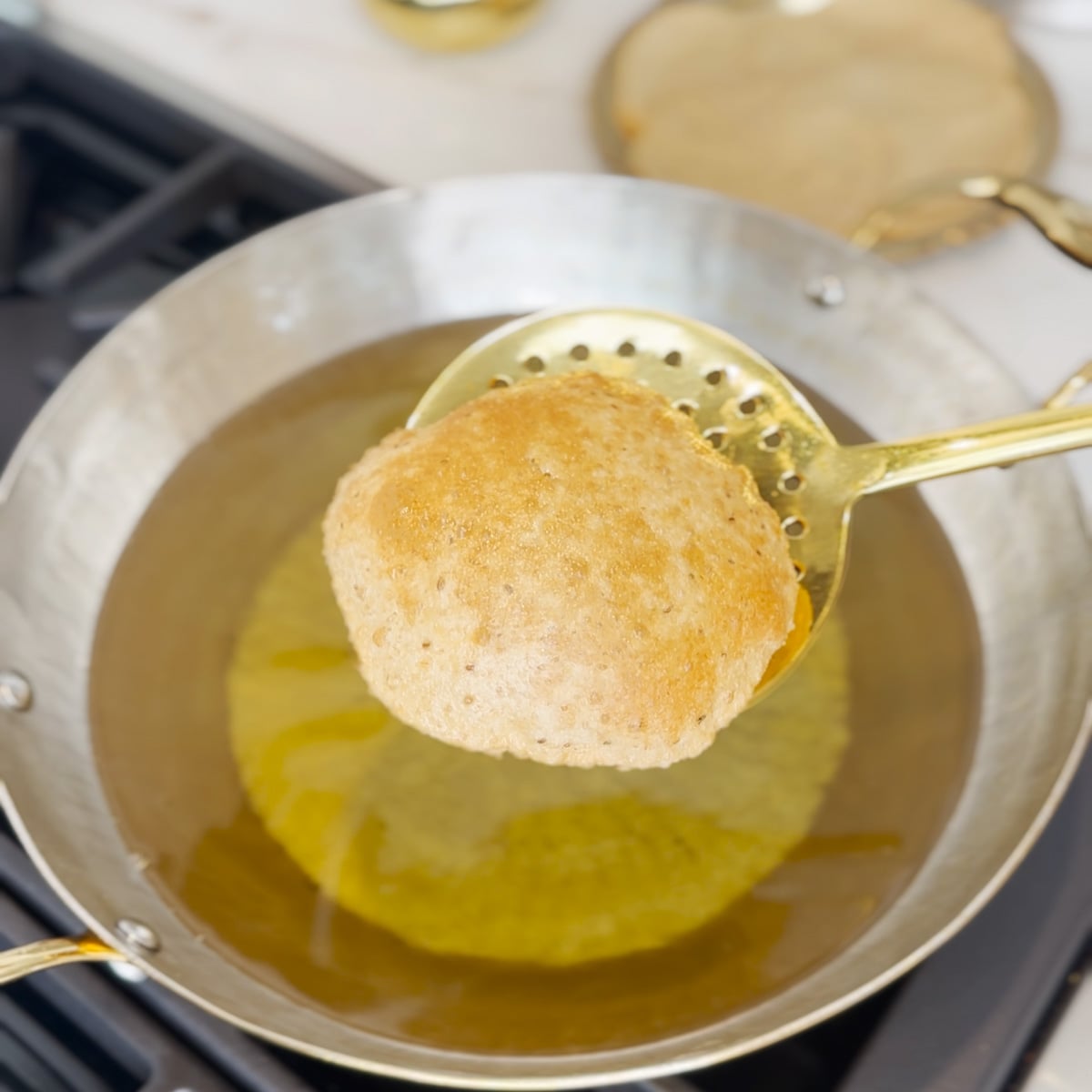 Puri in a ladle