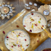 Instant pot Semiya Payasam served in 2 brass bowls garnished with nuts and rose petals.