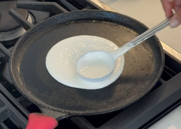 dosa batter on a cast iron for masala dosa recipe