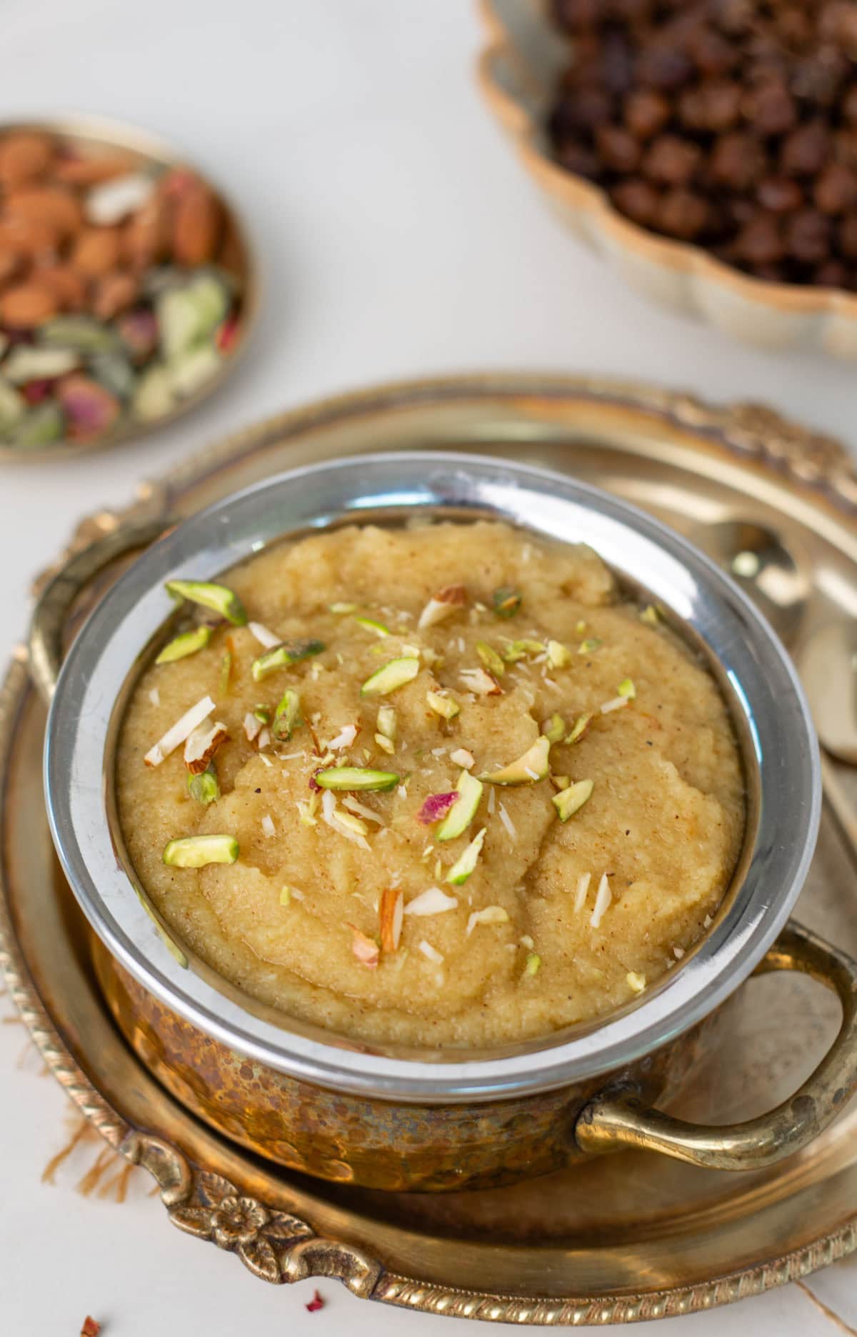 Sooji ka halwa (Sheera) served in a bowl, and topped with slivered nuts.