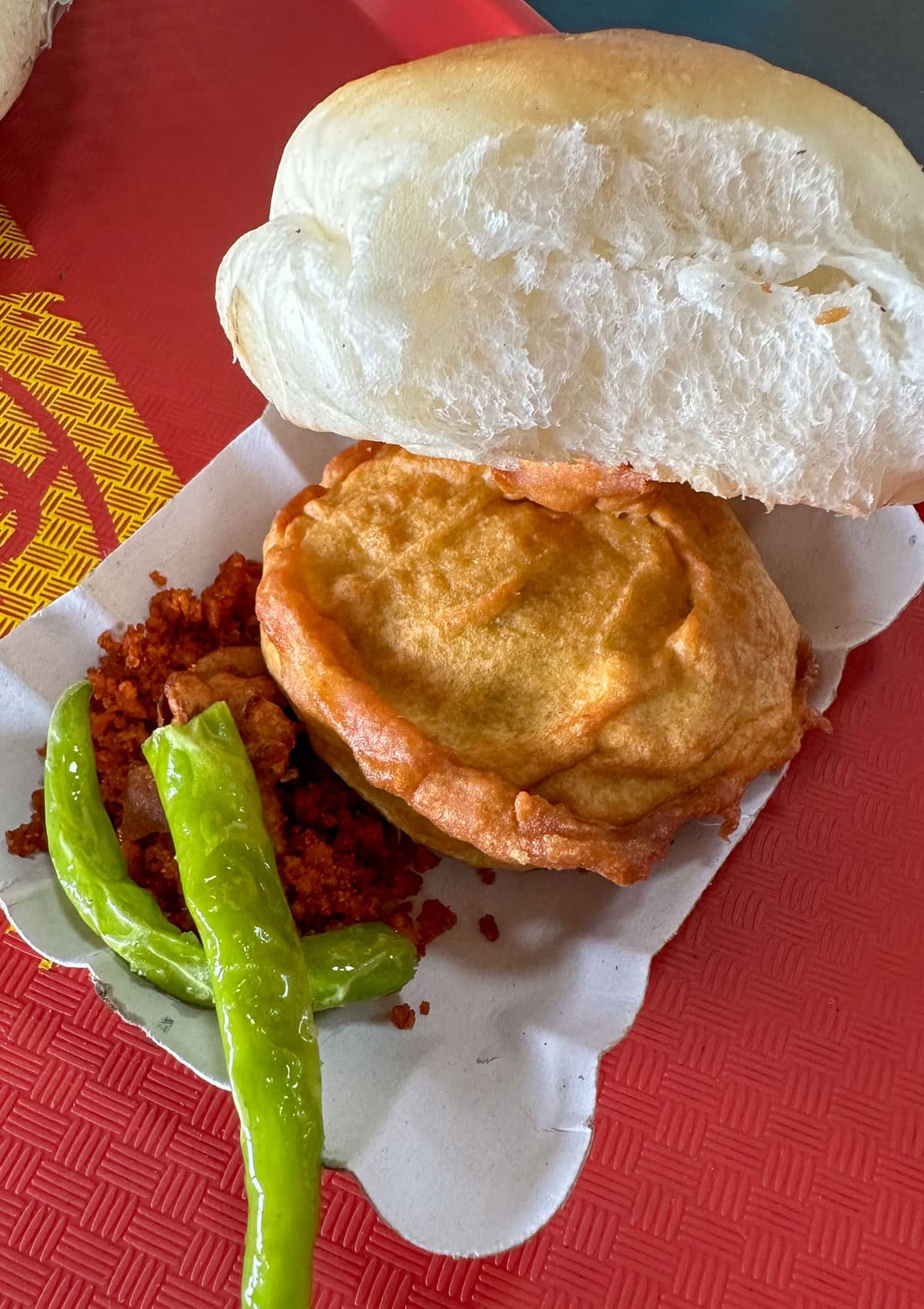 Street style vada pav with red garlic chutney and fried green chili.
