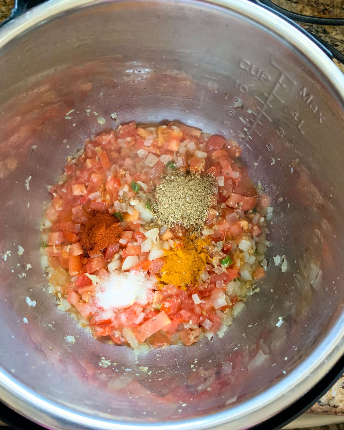 Saute aromatics, tomatoes and spices to make aloo baingan in instant pot