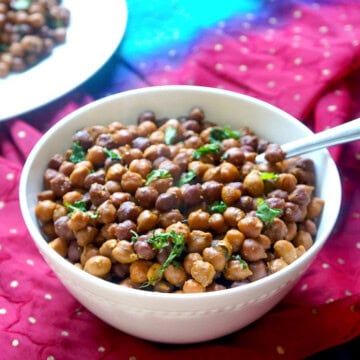 Instant Pot sookha kala chana served in a bowl and garnished with cilantro.