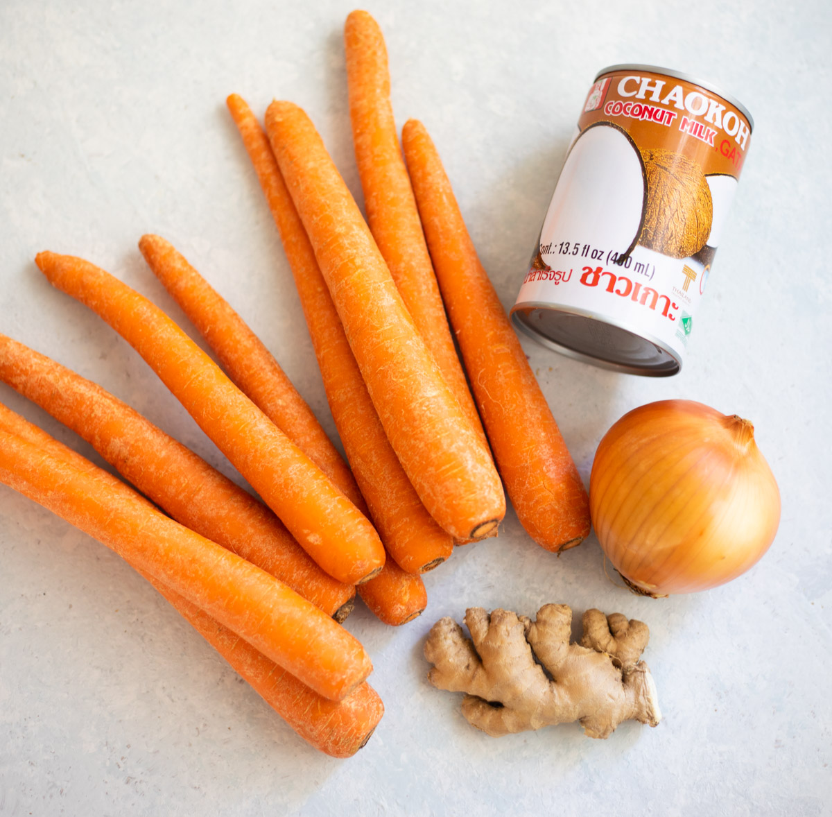 Ingredients to make carrot soup with ginger and coconut milk